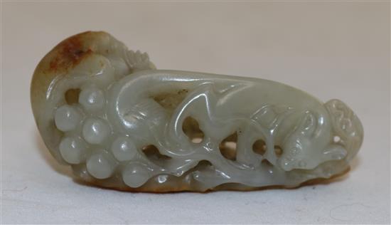 A Chinese celadon and russet jade squirrel and grape vine carving, 18th / 19th century, 6.8cm